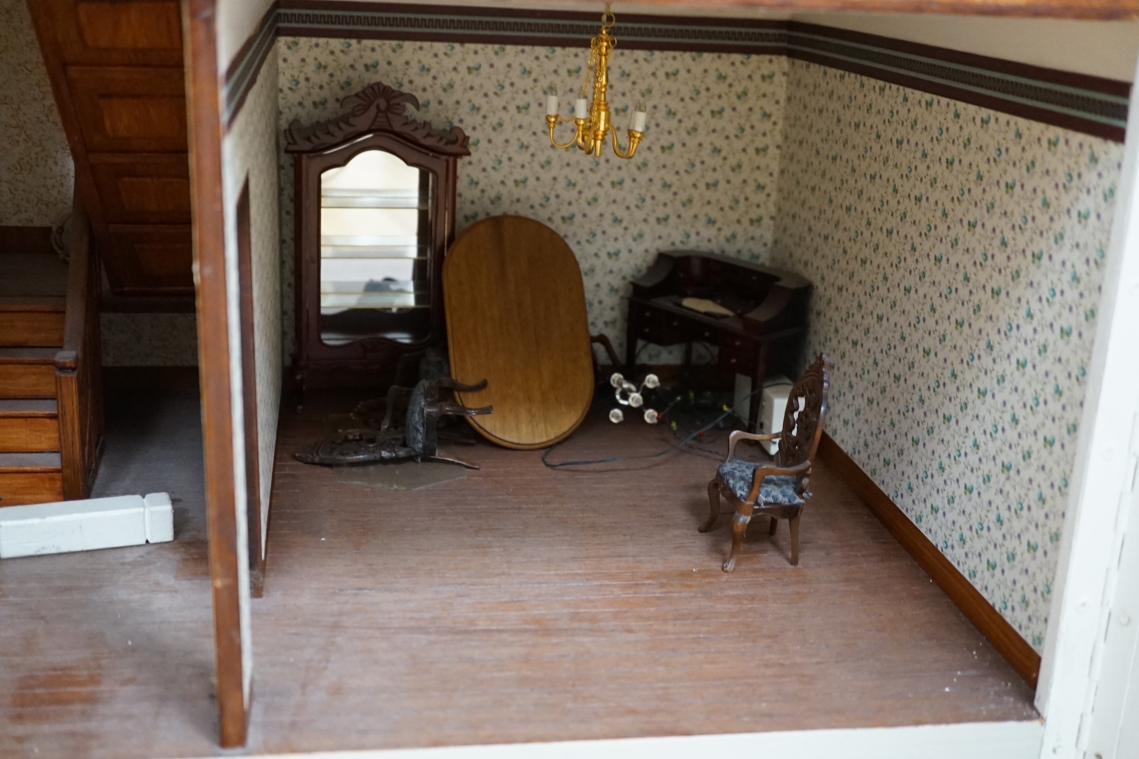 A modern Georgian style dolls house, with two front opening doors, containing six rooms with furnishings, figures, and electric lighting, together with a dolls shop, containing two rooms, furnishings, and accessories, et